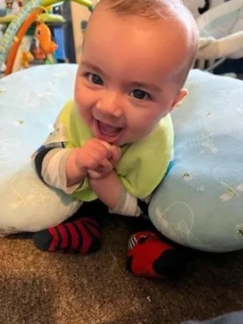 A smiling infant during tummy time